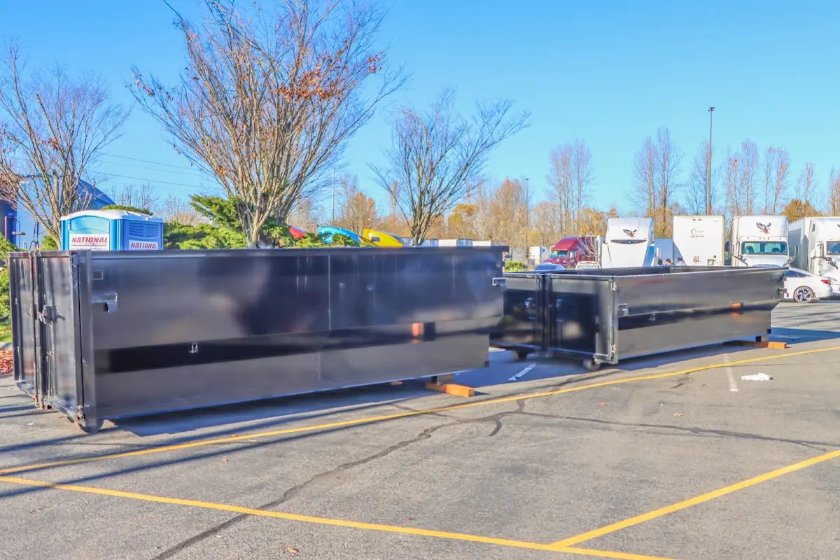 Professional dumpster rental service with roll-off container on residential driveway in Eastampton